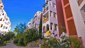 A residential building with multiple balconies and a stone pathway leading to the entrance. - Zahara Paradise - Ole Solutions (Zahara de los Atunes)