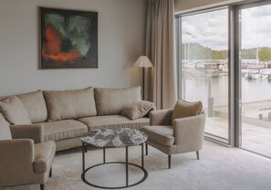 Premium Suite | Living area | 50-inch flat-screen TV with cable channels, heated floors - Season Hotel (Ekerö)