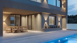 A modern two-story house with a pool, outdoor seating, and well-lit windows. - Villa Frantzeska (Zakynthos)