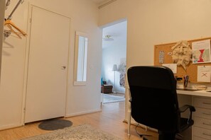 Work in comfort with a desk and office chair, computer, and ample storage.