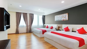 A hotel room with two beds, a flat-screen TV, and a painting on the wall. - Collection O Hotel Super Cowboy (Malacca City)