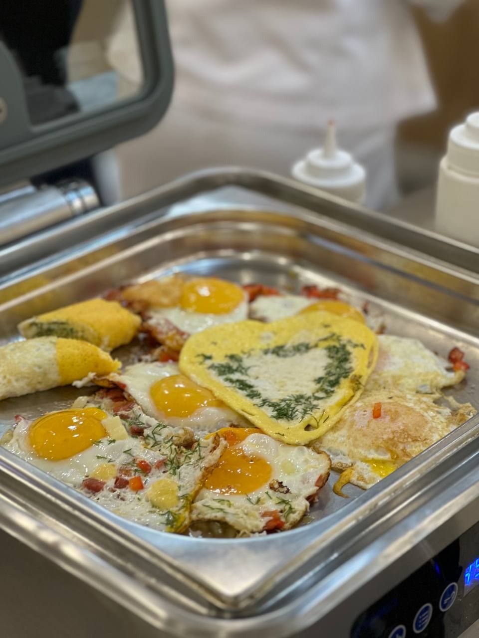 A buffet with various breakfast items including eggs, omelets, and possibly some vegetables.