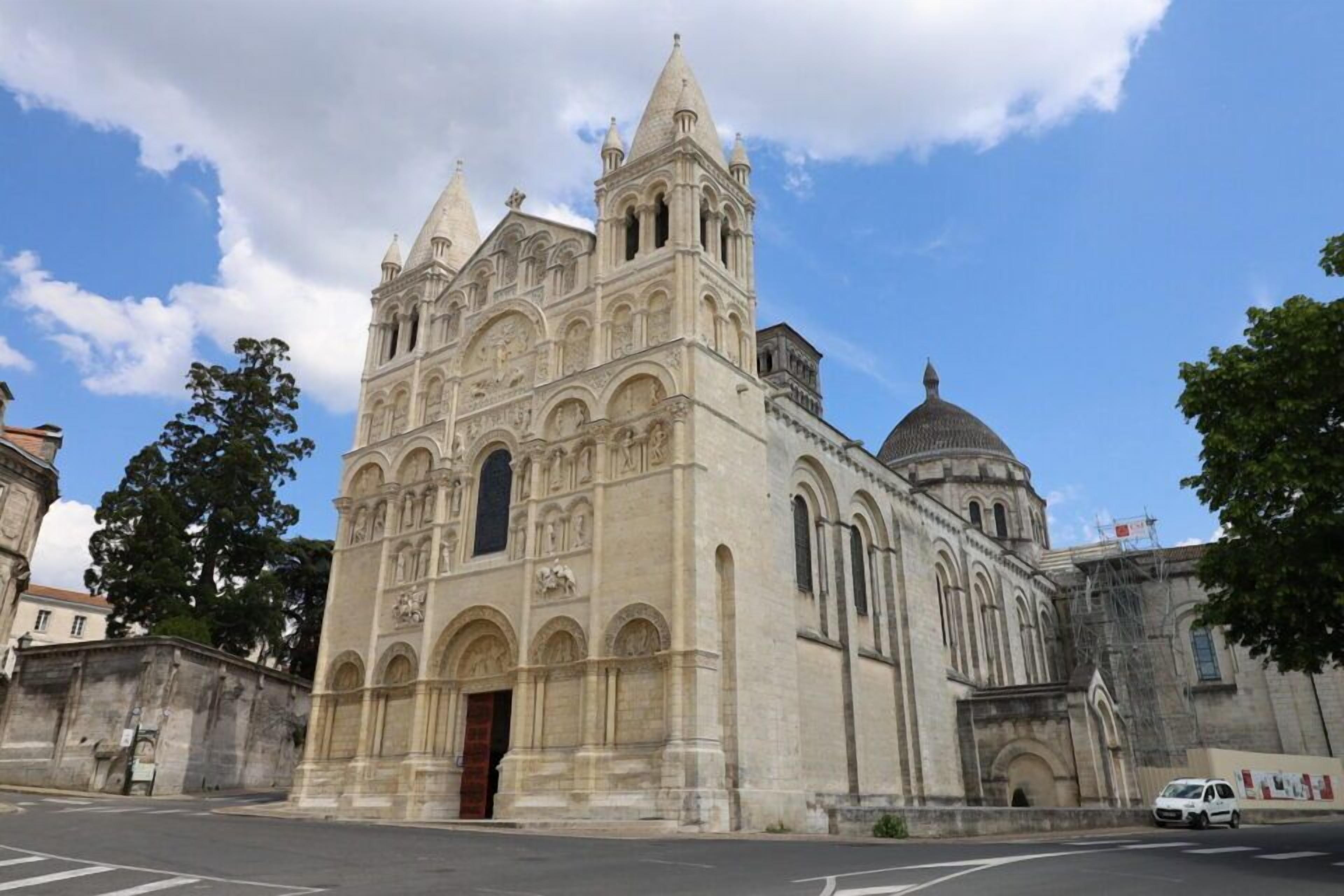 A historic cathedral with a large central dome and two bell towers.