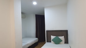 A small, clean room with a single bed, a bedside table, and a window with curtains. - Hotel O Signature Inn Miri (Miri)