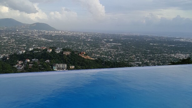 A view of a cityscape from a high vantage point, including a large body of water in the foreground. - Kingston view (Kingston)