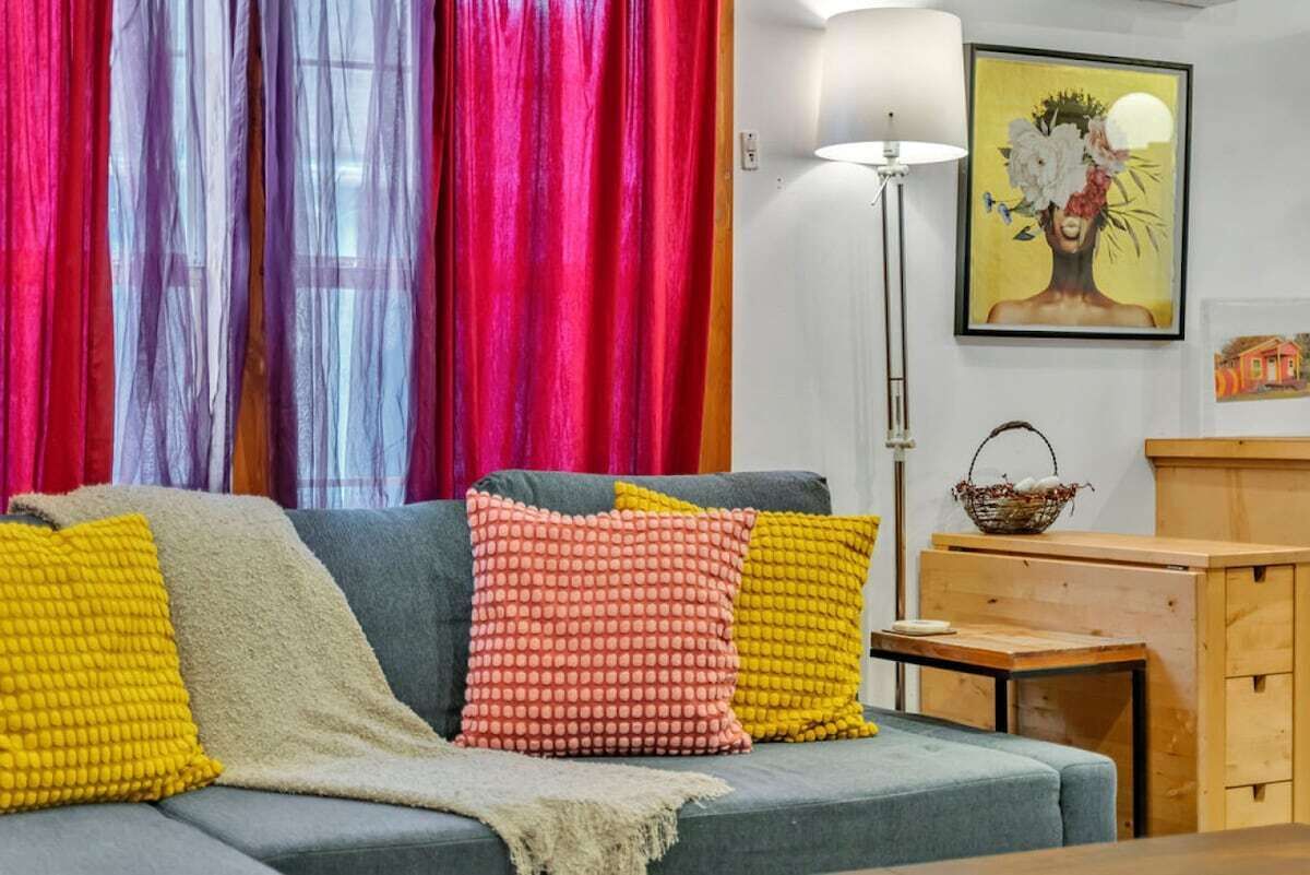 Additional seating nook with bright throw pillows and natural light