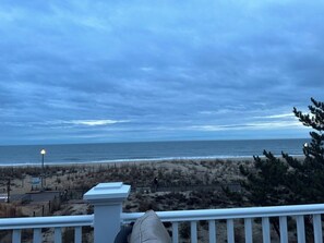 Enjoy breathtaking views of the ocean from this room's balcony overlooking the sandy beach.