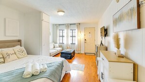 A well-lit bedroom with a bed, a desk, and a wardrobe. - Walk to North Myrtle Beach: Studio w/ Pool Access! (North Myrtle Beach)