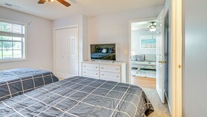 A bedroom with two beds, a TV on a dresser, and a ceiling fan. - Myrtle Beach Condo w/ Pool Access: 5 Mi to Ocean (Myrtle Beach)