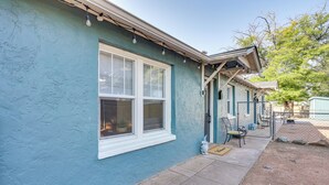 A house with a teal exterior, a white window, and a porch with a bench and a small table. - 4 Mi to Dtwn: Cozy Home in Pueblo (Pueblo)