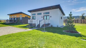 A modern two-story house with a covered porch and a small garden. - "the Farmhouse": Near Flathead Lake & Skiing (Kalispell)