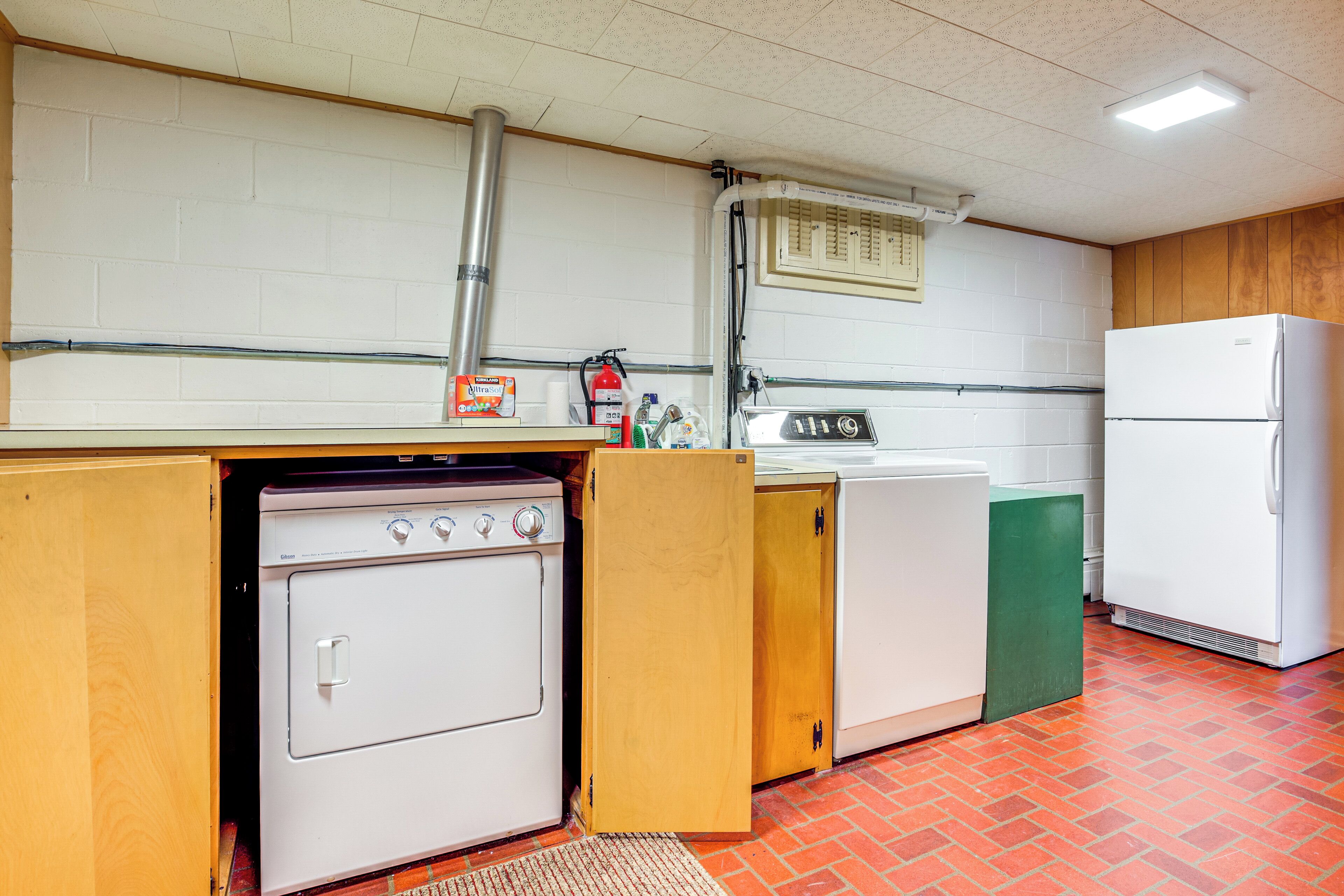A kitchen with a stove, sink, and refrigerator.