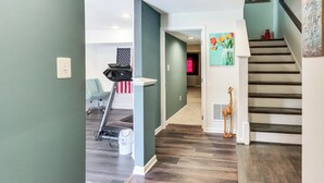 A home interior with a staircase, a treadmill, and a hallway leading to another room. - 2 Mi to Hollywood Casino: Charles Town Townhome! (Charles Town)