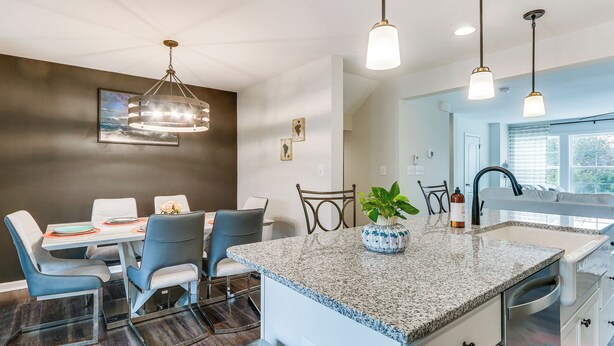 A modern kitchen with a granite countertop, stainless steel appliances, and pendant lighting. - 2 Mi to Hollywood Casino: Charles Town Townhome! (Charles Town)