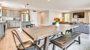 A modern kitchen with a large island, stainless steel appliances, and pendant lighting. - Walk to Beaches & Parks: Home w/ Deck in Laconia (Laconia)