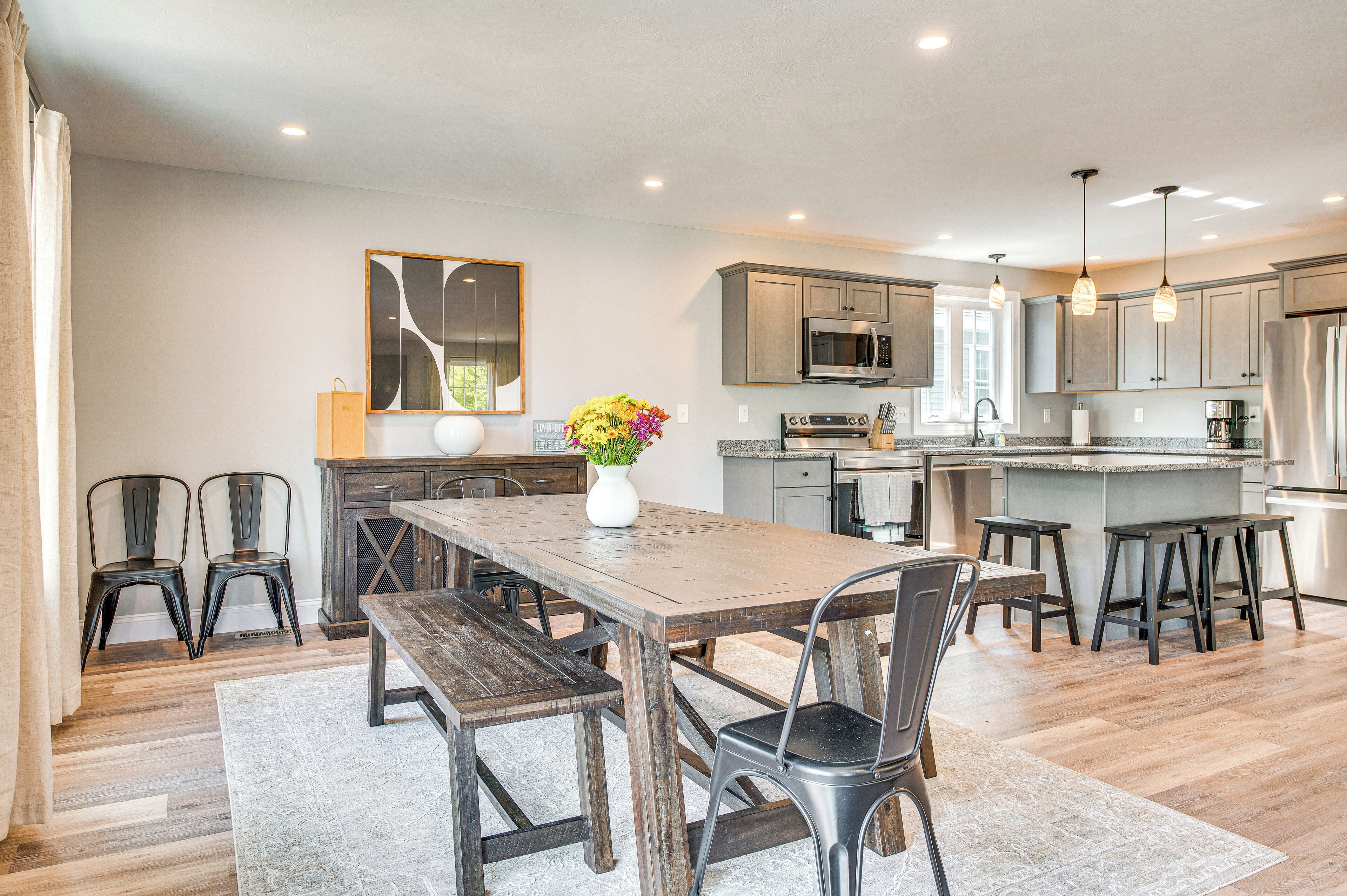 A spacious kitchen with a central island, modern appliances, and ample seating.