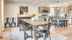 A spacious kitchen with a central island, modern appliances, and ample seating. - Walk to Beaches & Parks: Home w/ Deck in Laconia (Laconia)