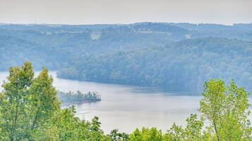 A lake surrounded by dense forest and hills.