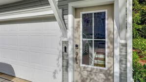 A garage door and a front door with a window. - 13 Mi to Dtwn Charleston: Quiet Townhome (Hanahan)