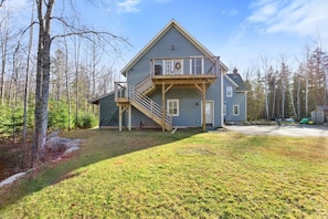 A two-story house with a balcony, a staircase, and a garage.
