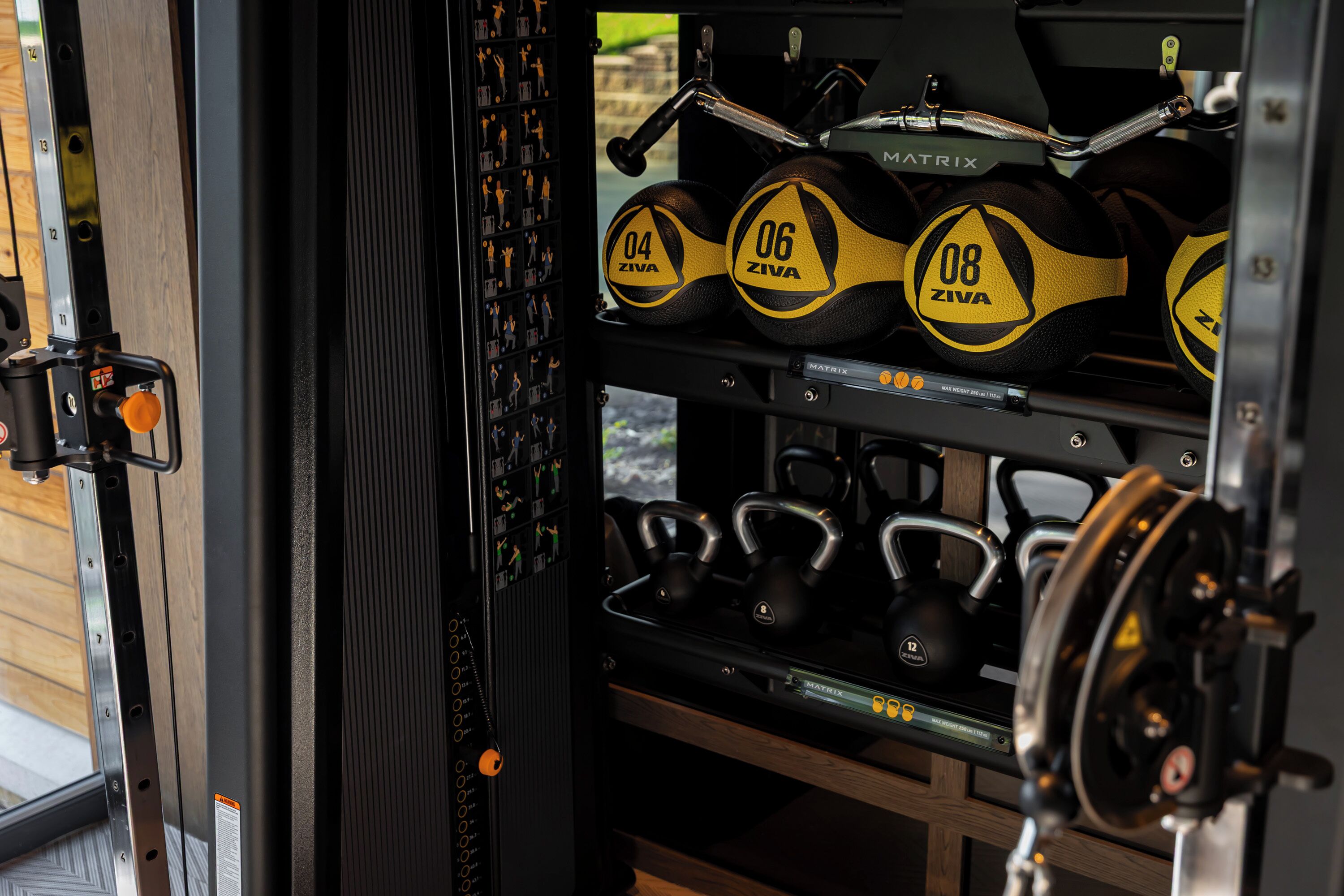 A weight training area with kettlebells and dumbbells.