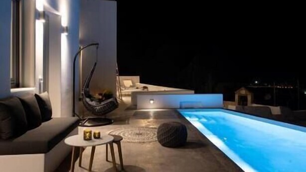 A modern outdoor living area with a pool, seating, and a hanging chair. - White Orchid Suites | 2 | Heated Shared Mini Pool (Vothonas)