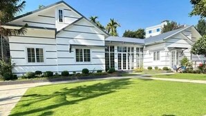 A modern two-story house with a well-maintained lawn and a driveway leading to the entrance. - Secret Paradise Sylhet (Sylhet)