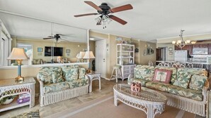 A living room with two sofas, a coffee table, a ceiling fan, and a kitchen area in the background. - 3BR/3BA Close to Main St-Oceanfront-Tidemaster 301 (North Myrtle Beach)