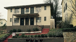 A two-story building with a red front entrance and a balcony. - DOWNTOWN AT CUTE AND COZY  (Atlanta)