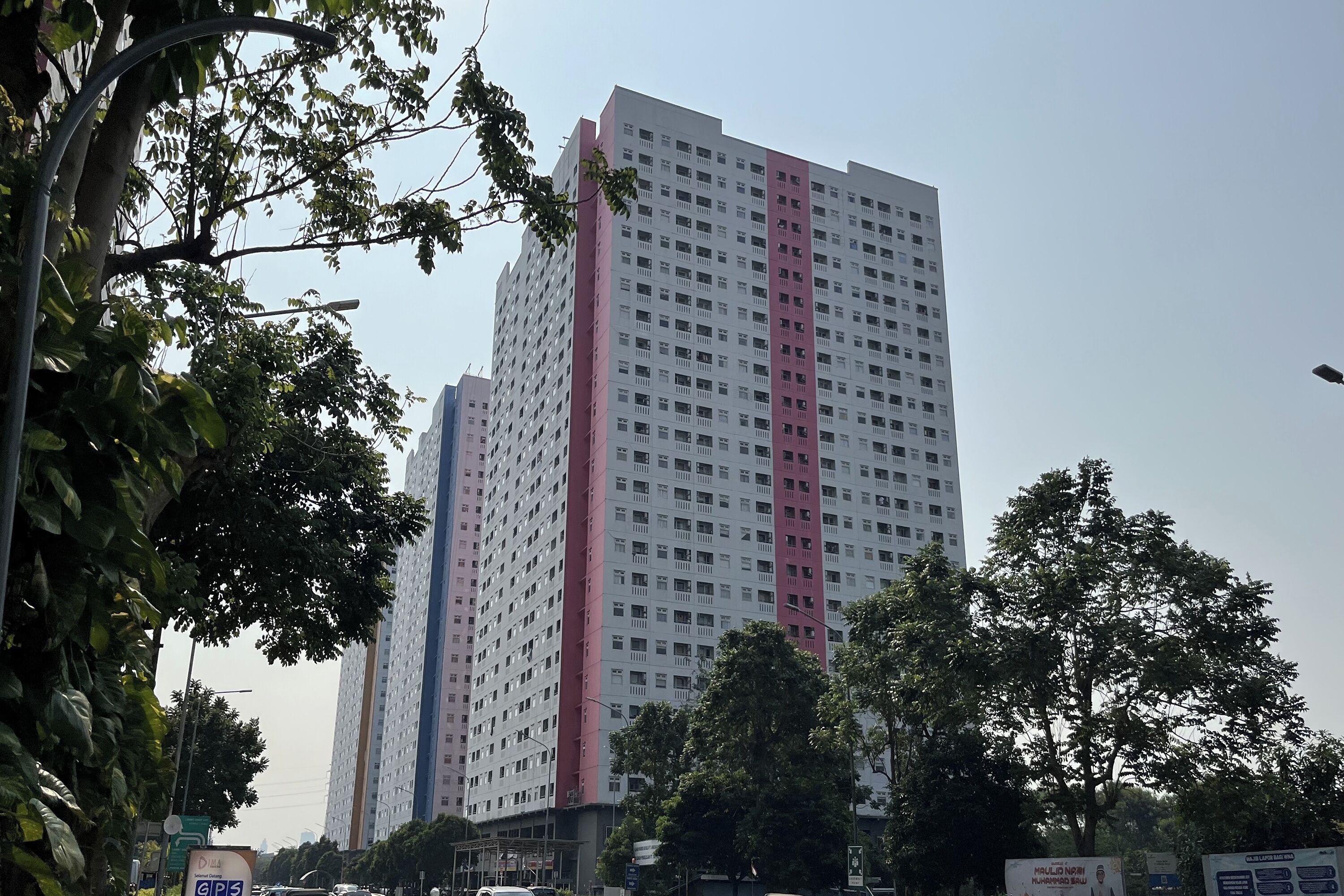 A tall residential building with multiple floors and balconies.