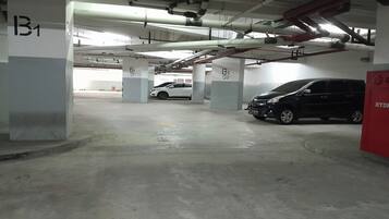 A multi-level parking garage with concrete pillars labeled B1 and G2.
