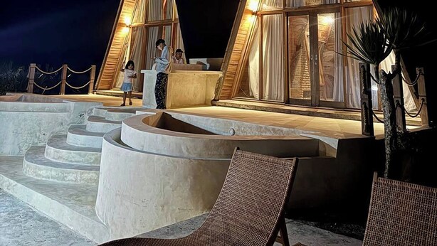 Two triangular-shaped buildings with large windows, a pool area with steps leading to the buildings, and outdoor seating. - Volcano Side Kintamani Bali (Kintamani)