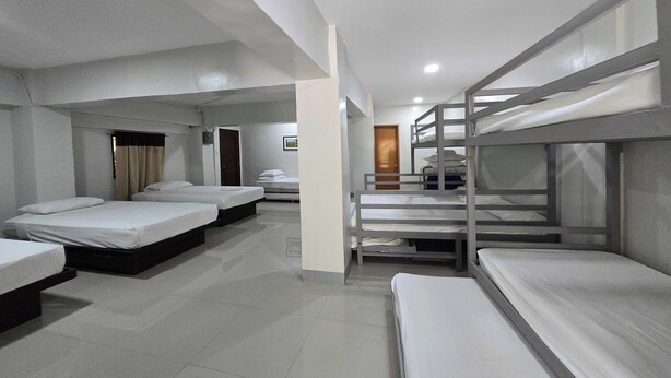 A dormitory-style room with bunk beds and individual beds. - Amazing View Mountain Farm Resort (Mabitac)
