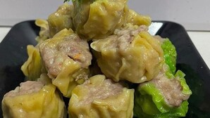 A plate of dumplings with a garnish of parsley.