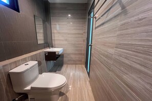 Une salle de bain moderne avec des toilettes, un lavabo et un miroir.