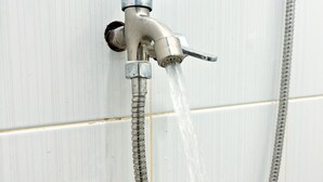 A wall-mounted shower with a flexible hose. - Semarang Inn (Semarang)