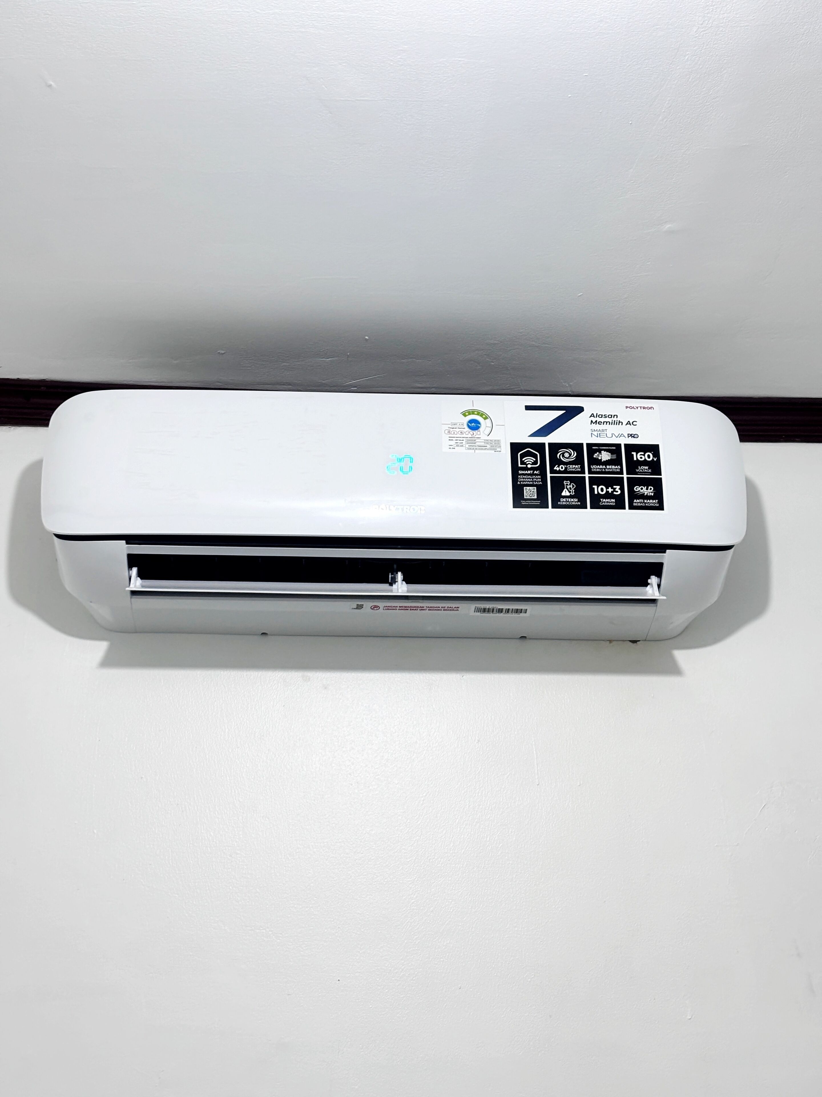 A white wall-mounted air conditioner with a digital display and control panel.