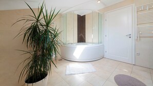 A modern bathroom with a glass-enclosed jacuzzi, a potted plant, and a white door. - Hedera Estate, Villa Hedera XIX (Mlini)