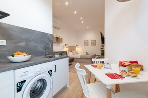A compact living space with a kitchen, dining area, and a small living room.