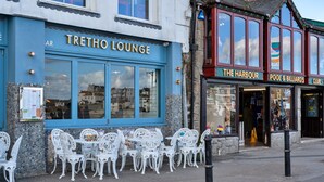 A building with a blue facade and the name "TRETHO LOUNGE" on the front. - No. 6 Porthgwidden (St Ives)