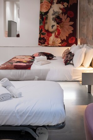 A hotel room with two beds, a large floral artwork on the wall, and a modern design. - Bhr Brancaccio 83 (Rome)