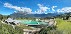 A mountain resort with a large swimming pool, chalet-style buildings, and a view of the Alps. - Superb chalet  14 guests in Combloux Megeve (Combloux)