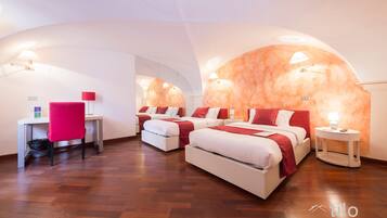 A modern hotel room with two beds, a desk, and a chair.