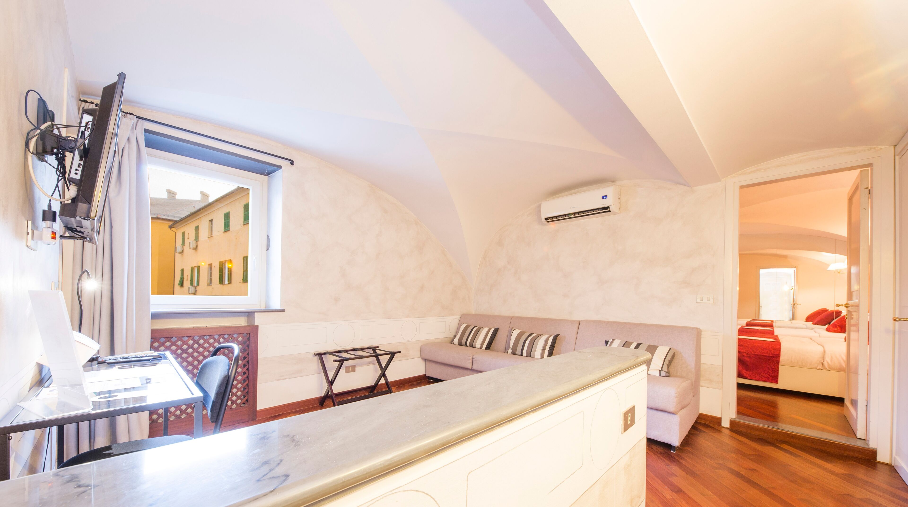 A compact living space with a kitchen area, a dining table, and a sofa.