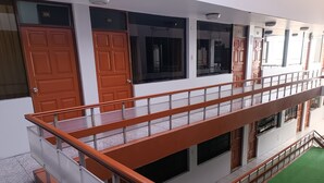 A multi-level building with a balcony, doors numbered 308 and 309, and a green carpeted area. - HOTEL HAYLLI INN (Arequipa)