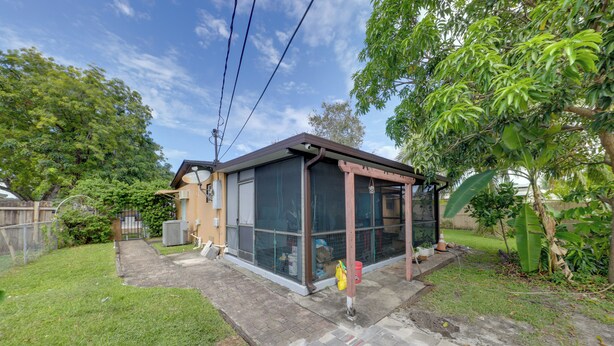 A house with a fenced backyard, a small porch, and a covered outdoor area. - 8 Mi to Beach: Pet-Friendly Fort Lauderdale Studio (Fort Lauderdale)