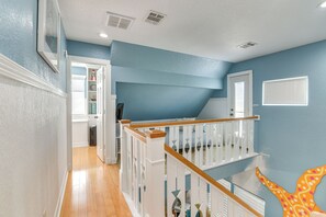 A staircase with white railings and wooden steps leading to a second floor. - Ocean Views: Pet-Friendly Surfside Beach Gem (Surfside Beach)