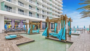 A cruise ship's outdoor pool area with wooden loungers and a wooden pergola structure. - Bright & Stylish Stay at Splendid Resort - Prime Location and Stunning Views (Hollywood)