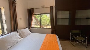 A room with a bed, a desk, and a window with curtains. - Home Investments Villa (Moshi)
