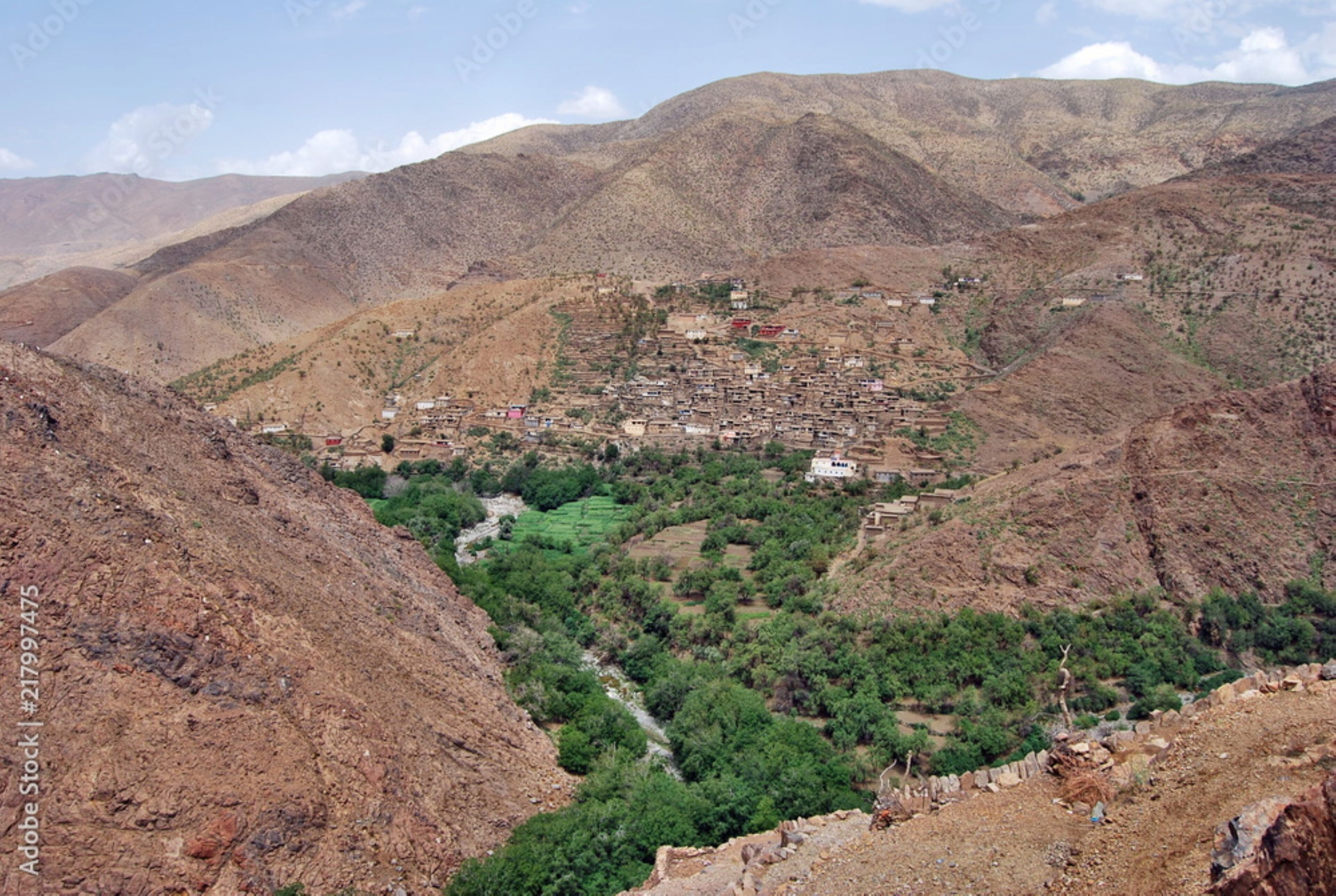 A mountainous landscape with a small settlement nestled among the hills.
